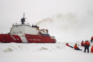 After breaking free from its anchor on the ice, Healy realigns to allow the crew to board. The crew waits behind an ice ridge.